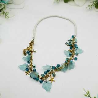 Handmade ocean-inspired necklace with white stone beads and turquoise charms