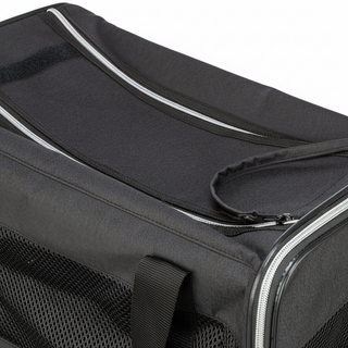 Black pet carrier with mesh side and zipper closure on a white background