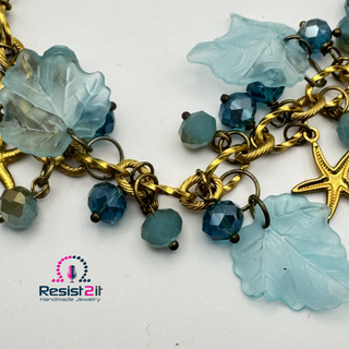 Close-up of handmade beach necklace with Czech glass beads and resin leaves