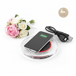 AURA™ Wireless Charger with smartphone, styled with pink and white roses on a white background