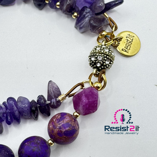 Detail of Violet Duality™ handmade amethyst bracelet  showing amethyst chips and gold colored seed beads and a rhinestone magnetic clasp with a charm