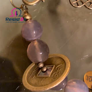 Faceted grey agate beads and vintage lucky coin charm detail in Chakra Explosion bracelet