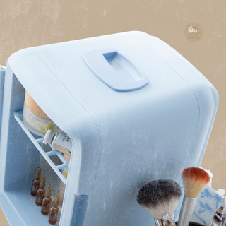 Small blue FRESCA™ refrigerator with cosmetic items and makeup brushes on a beige background