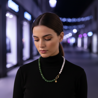 Woman wearing a black turtleneck and green/white beaded MIDNIGHT REFLECTIONS™ necklace in an urban setting