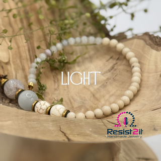Mixed Feelings™ single purple gemstone bracelet with the purple one detached, ready to be worn by woman, featuring the Resist2it brand