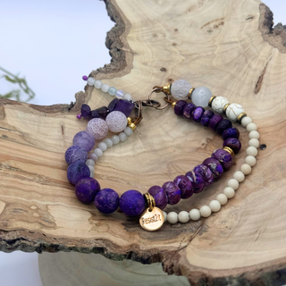 Handcrafted Mixed Feelings™ bracelet with purple jasper, agate, and natural wood beads, resting on a reclaimed wooden surface — Jewelry by Jules featuring Resist2it