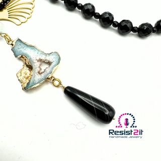 Necklace with black beaded chain and a unique pendant on a white background, featuring 'Resist2it Handmade Jewelry' logo.