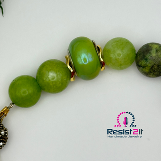 ON THE GREEN bracelet featuring multiple shades of green natural stones, featuring the Resist2it logo