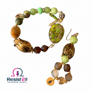 Jewelry set with beads and gold accents on a reflective surface, featuring Resist2it Handmade Jewelry logo.
