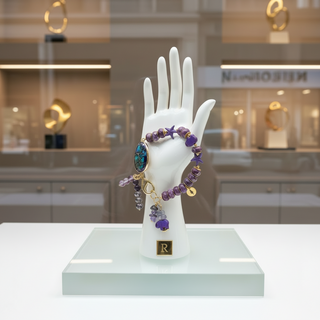 Jewelry display with PURPLE TIDES™ handmade bracelet on a mannequin hand with an R from Resist2it in a store setting
