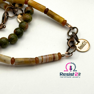 Beaded bracelet with a 'Resist2it' tag on a white background