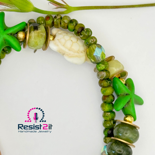 Green beaded bracelet with starfish charm on a white background, featuring Resist2it Handmade Jewelry logo.