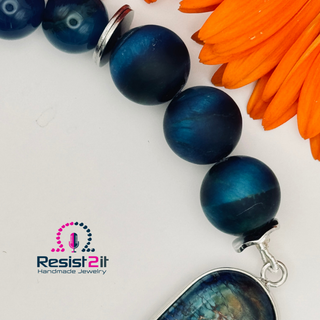 Detail of a natural blue stone beads  bracelet with sediment connector by Resist2it