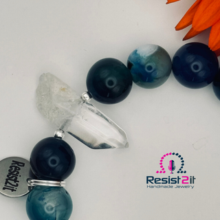 Details of a handmade bracelet with blue beads and a crystal