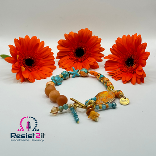 TURANCIA™ handmade bracelet with poppy jasper centerpiece and coastal color palette, with Resist2it charm