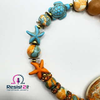 Turquoise howlite turtle and starfish beads on TURANCIA™ bracelet by Jewelry by Jules.