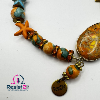 Close-up of carnelian agate and calcite beads on the TURANCIA™ handmade bracelet by Jewelry by Jules.