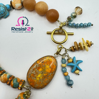 Dragon vein agate and sea star beads on the TURANCIA™ handmade bracelet.