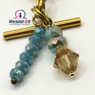Detail of the TURANCIA™ handmade bracelet by Resist2it, showing faceted Czech glass beads and Swarovski crystal.