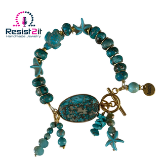 Turquoise Beach bracelet with ocean-inspired stones, turtle and starfish charms on a white background with Resist2it logo