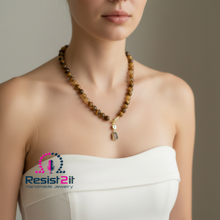 Woman wearing UNSPOKEN™ statement necklace with detachable agate slice, featuring the Resist2it logo.