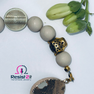 White Sands bracelet with Resist2it logo – premium handmade jewelry with gold and bronze accents